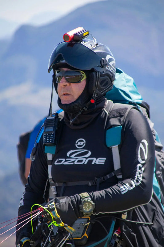 a man in a wet suit carrying a parachute