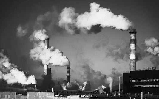 Factory chimneys are releasing smoke into the air.